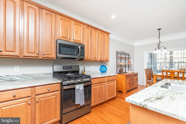 kitchen with pendant lighting, crown molding, light hardwood / wood-style flooring, stainless steel appliances, and a chandelier