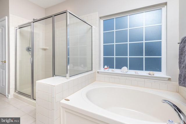 bathroom featuring plus walk in shower and tile patterned flooring