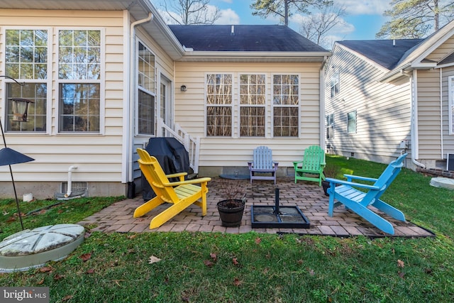 back of property featuring a patio area and a lawn