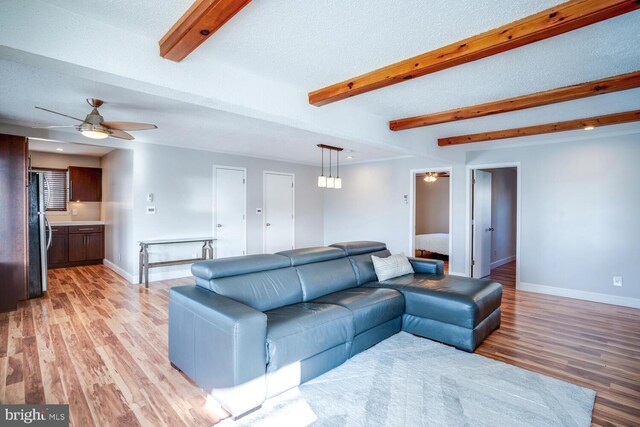 1427 Paul Blvd, Manahawkin, NJ 08050 - living room featuring beam ceiling, light wood-style flooring, a ceiling fan, and baseboards