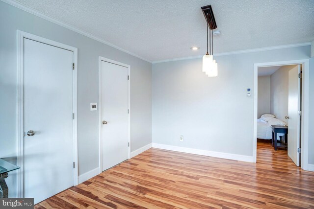 1427 Paul Blvd, Manahawkin, NJ 08050 - interior space with baseboards, a textured ceiling, wood finished floors, and crown molding