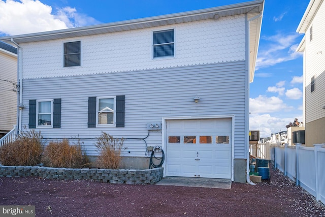 1427 Paul Blvd, Manahawkin, NJ 08050 - rear view of house featuring an attached garage, fence, and driveway