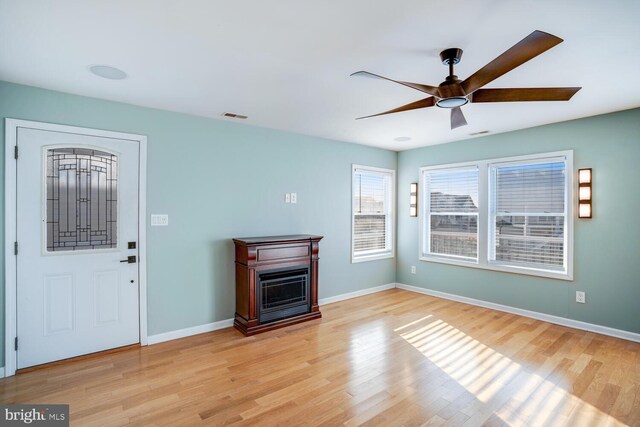 1427 Paul Blvd, Manahawkin, NJ 08050 - unfurnished living room with a fireplace, wood finished floors, baseboards, and ceiling fan