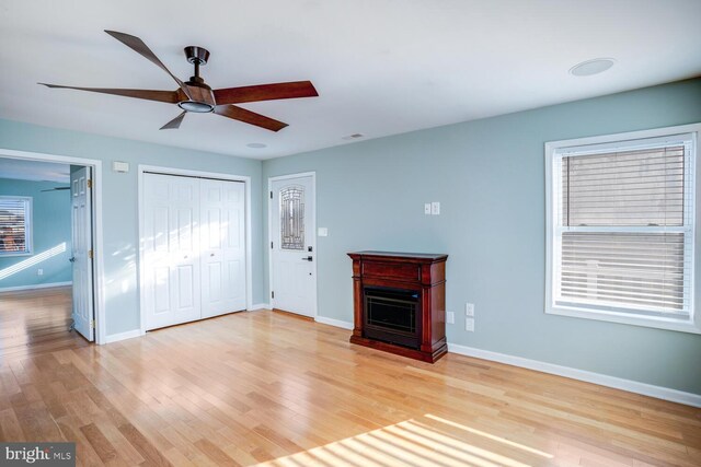 1427 Paul Blvd, Manahawkin, NJ 08050 - unfurnished living room featuring plenty of natural light, a fireplace, light wood finished floors, baseboards, and ceiling fan