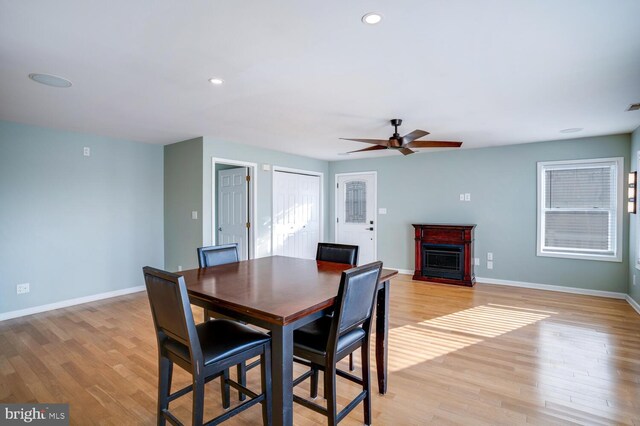 1427 Paul Blvd, Manahawkin, NJ 08050 - dining space with a fireplace, baseboards, light wood-type flooring, and ceiling fan