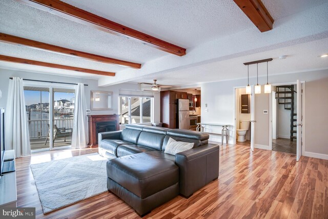 1427 Paul Blvd, Manahawkin, NJ 08050 - living area featuring light wood-type flooring, beamed ceiling, and a textured ceiling