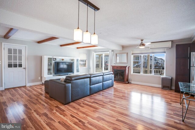 1427 Paul Blvd, Manahawkin, NJ 08050 - living area with a textured ceiling, an AC wall unit, a ceiling fan, and beam ceiling