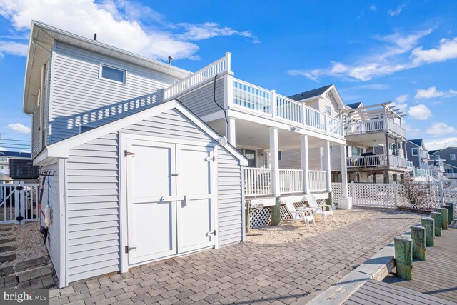 1427 Paul Blvd, Manahawkin, NJ 08050 - rear view of property featuring a storage shed and an outdoor structure