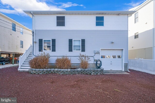 1427 Paul Blvd, Manahawkin, NJ 08050 - view of front facade featuring stairs, an attached garage, and fence