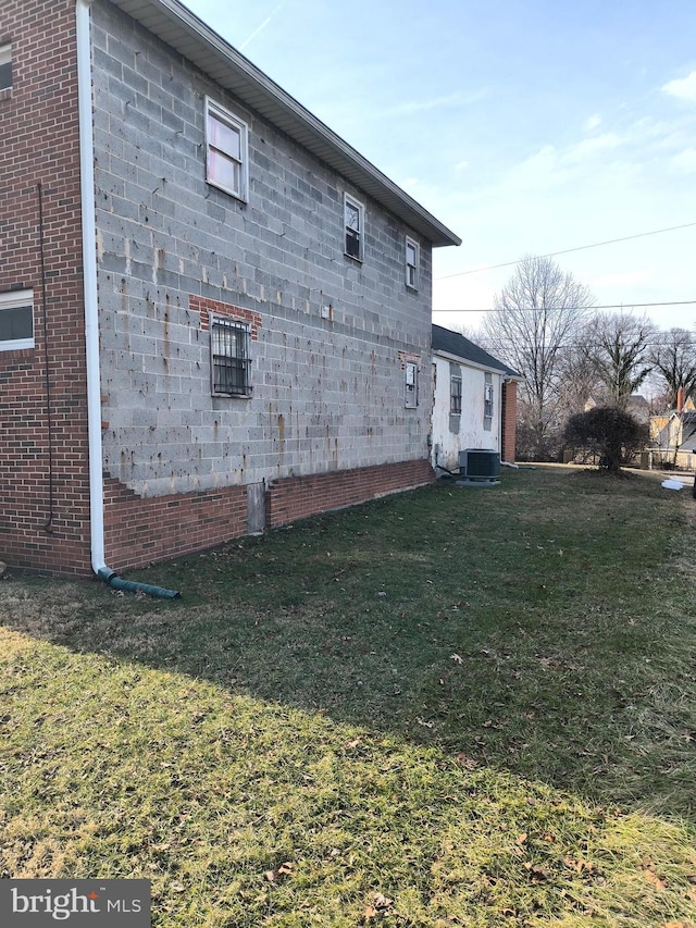 view of home's exterior featuring a yard and central AC