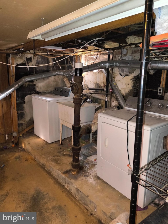 basement featuring separate washer and dryer and sink