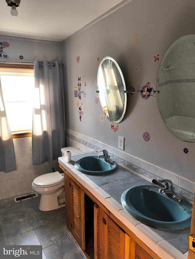 bathroom with tasteful backsplash, vanity, and toilet