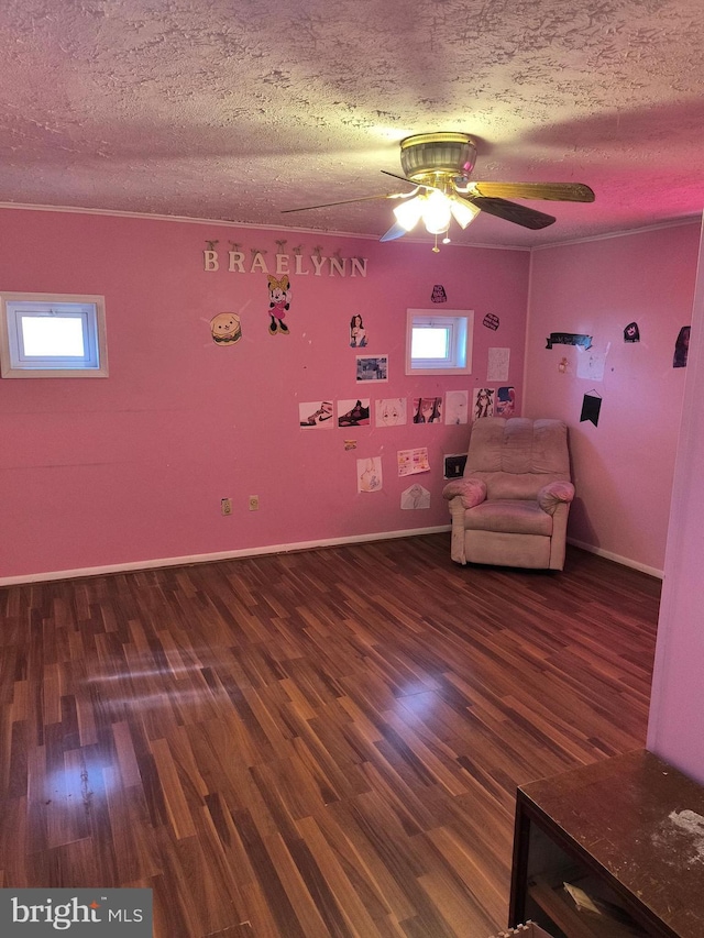 unfurnished room with ceiling fan, wood-type flooring, and a textured ceiling