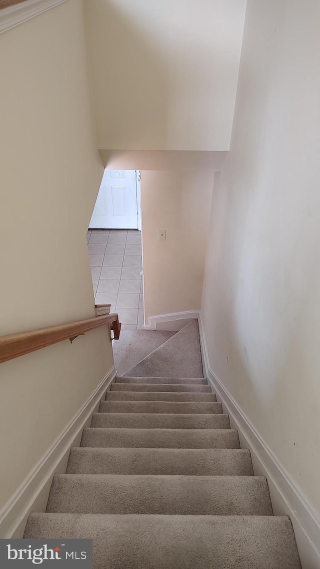 staircase featuring tile patterned floors