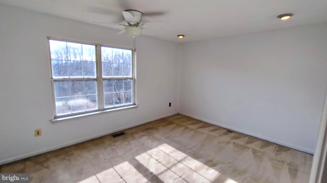 carpeted empty room with ceiling fan