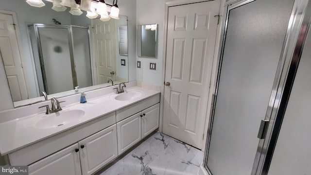 bathroom with a shower with door and vanity