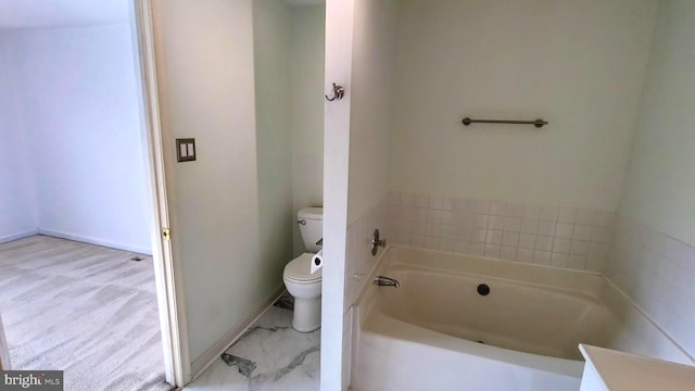 bathroom featuring a washtub and toilet