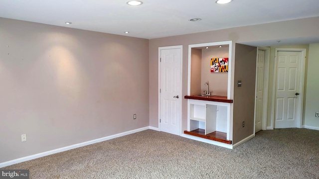 carpeted spare room featuring sink