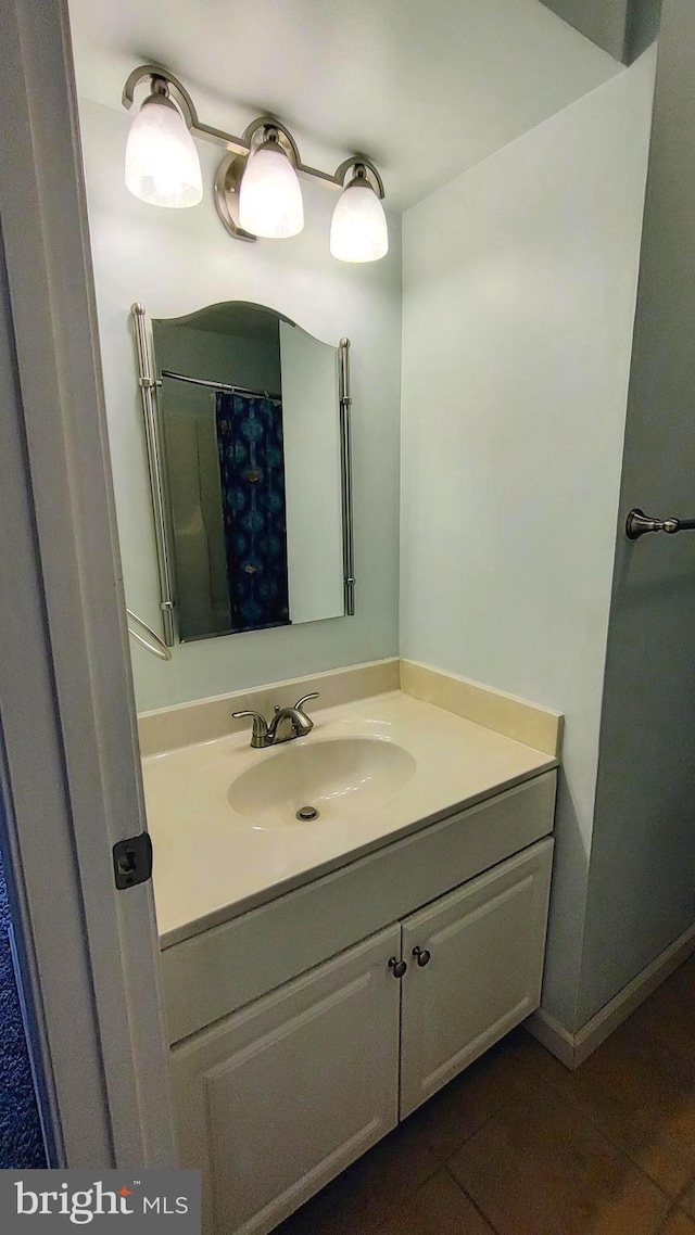 bathroom featuring a shower with shower curtain, vanity, and tile patterned flooring