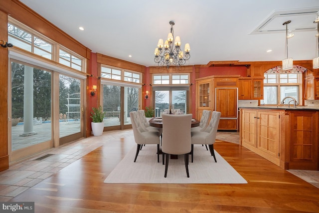 dining room featuring an inviting chandelier, light wood-type flooring, visible vents, and recessed lighting