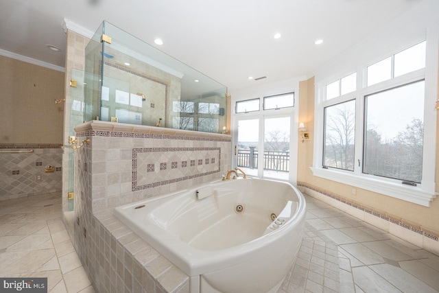 bathroom with a stall shower, crown molding, tile walls, and a whirlpool tub