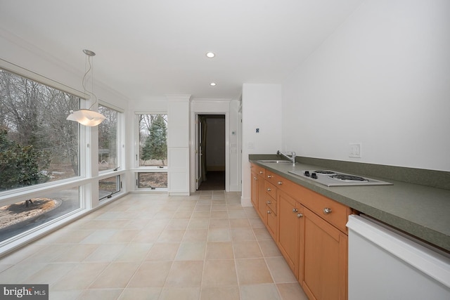 kitchen featuring white appliances, a sink, brown cabinets, dark countertops, and decorative light fixtures