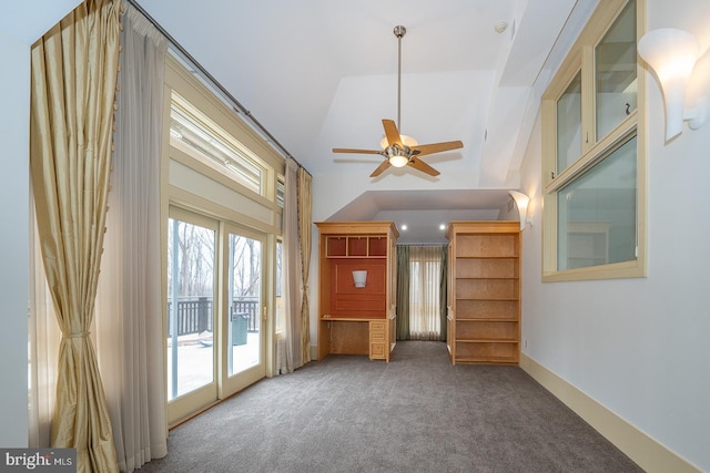 unfurnished room featuring high vaulted ceiling, baseboards, a ceiling fan, and carpet flooring