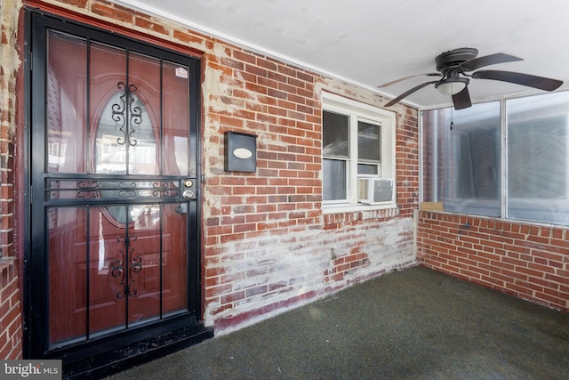 view of exterior entry featuring ceiling fan and cooling unit