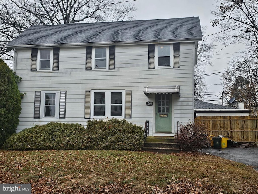 colonial-style house with a front yard