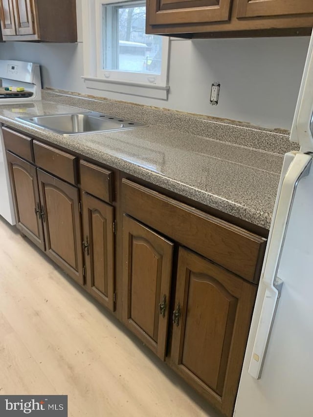 kitchen with light hardwood / wood-style floors and stove