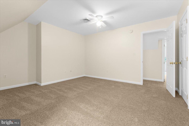 interior space with ceiling fan, lofted ceiling, and light carpet