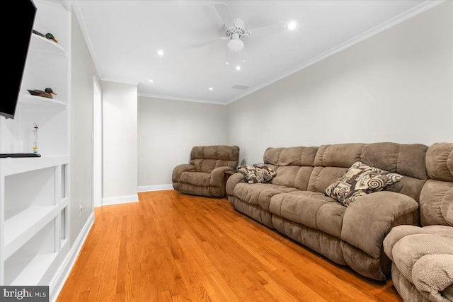 living room with ceiling fan, light hardwood / wood-style flooring, and crown molding