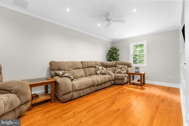 living room with hardwood / wood-style flooring, ceiling fan, and ornamental molding