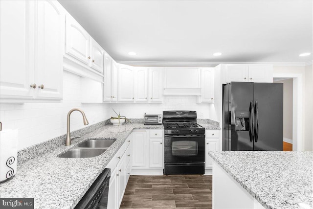 kitchen with light stone countertops, tasteful backsplash, sink, black appliances, and white cabinets