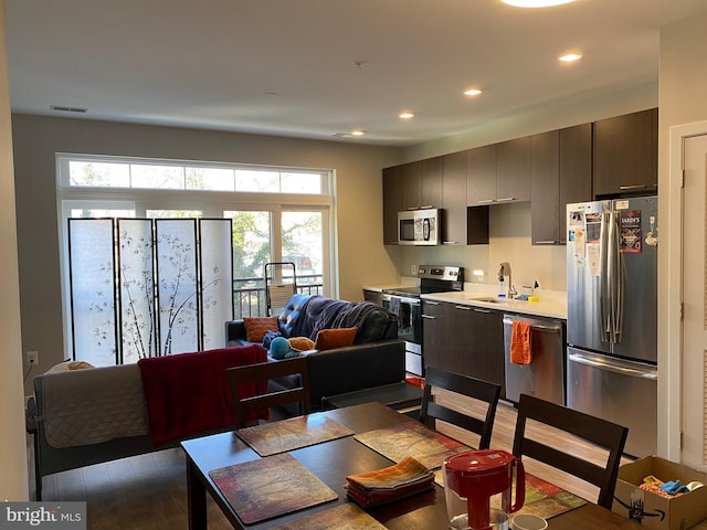 dining space with sink, plenty of natural light, and wood-type flooring