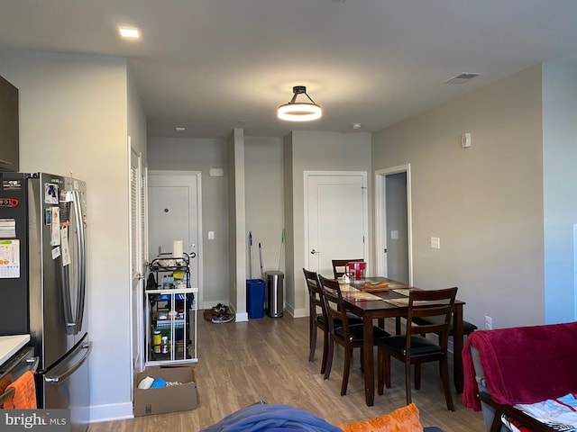 dining space with hardwood / wood-style floors