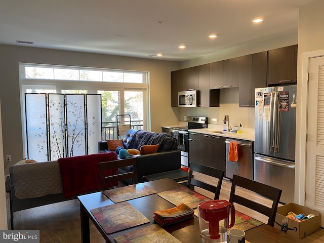 dining room featuring wood-type flooring and sink