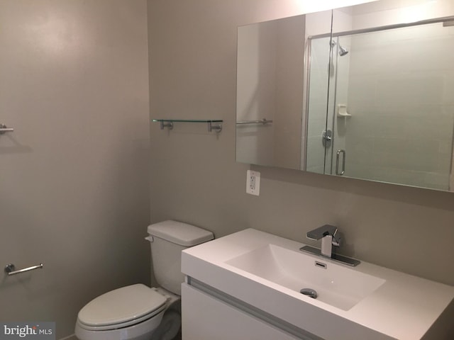 bathroom with walk in shower, vanity, and toilet