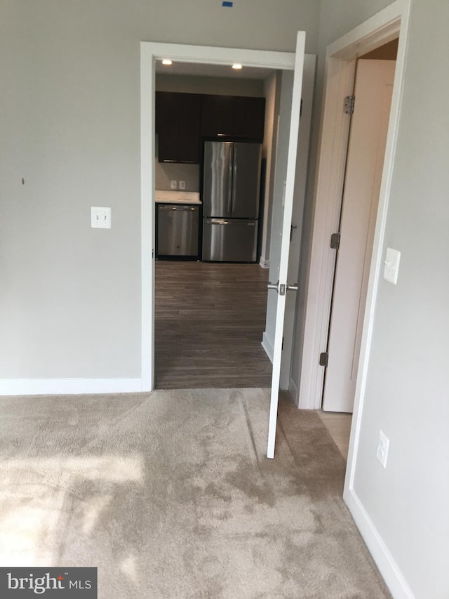 hallway featuring light carpet