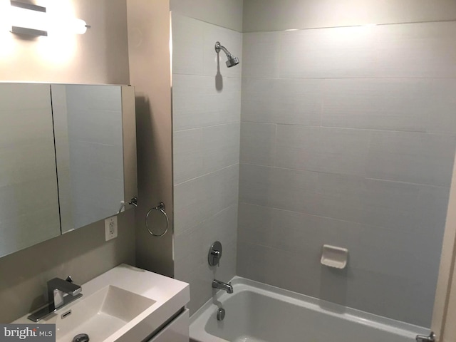 bathroom with vanity and tiled shower / bath combo