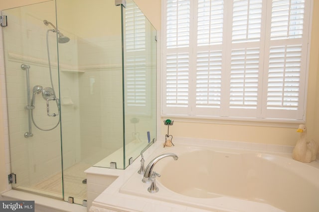 bathroom featuring separate shower and tub