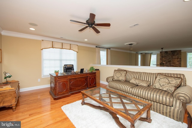 living room with ceiling fan, light wood-type flooring, and crown molding