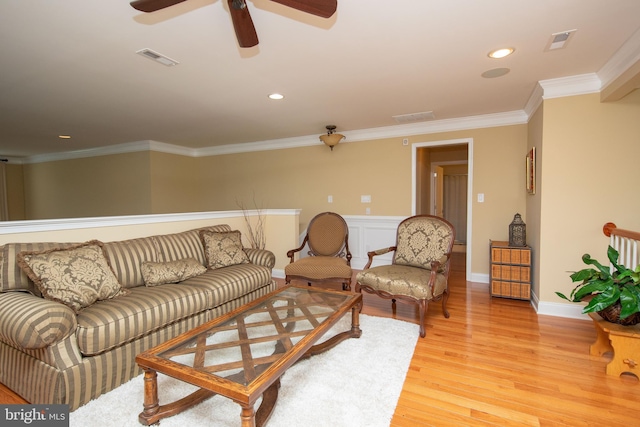 living room featuring ceiling fan, light hardwood / wood-style floors, and ornamental molding