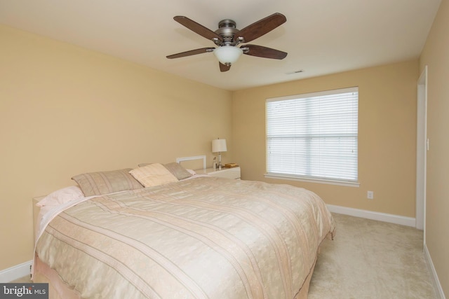 bedroom with ceiling fan and light carpet