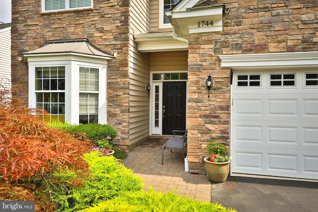 entrance to property with a patio area and a garage