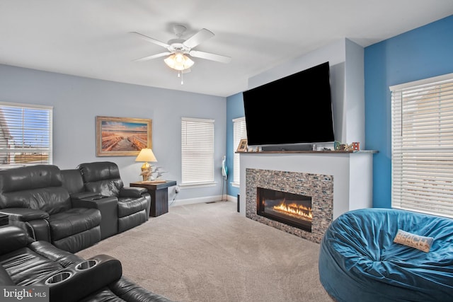 carpeted living room featuring a wealth of natural light, ceiling fan, and a fireplace