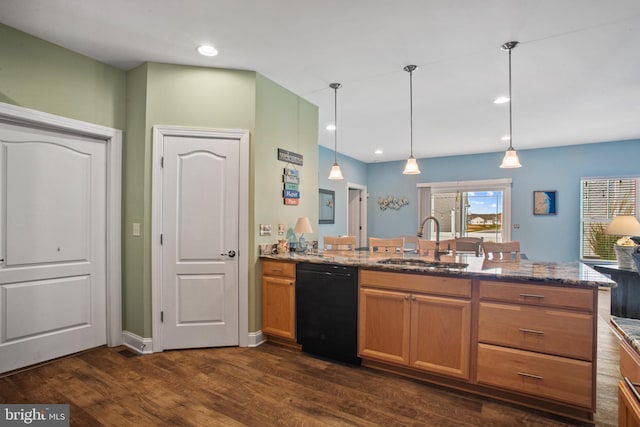 kitchen featuring dishwasher, sink, dark hardwood / wood-style floors, dark stone countertops, and decorative light fixtures