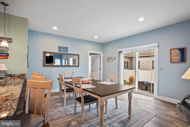 dining area featuring dark wood-type flooring