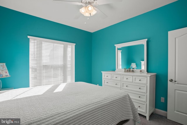 bedroom featuring ceiling fan and light carpet