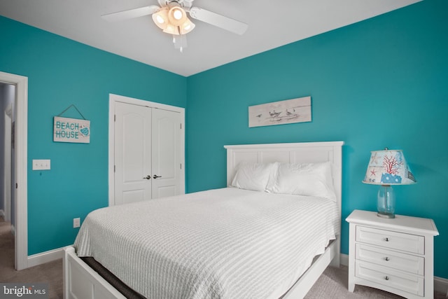 carpeted bedroom with a closet and ceiling fan